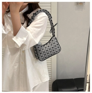 Detail of gingham shoulder bag with bow accents and ruched cloud strap for women