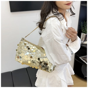 Detail showing high-quality gold sequin texture and leather strap on a shoulder bag