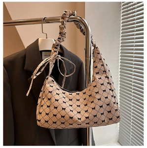 Detail of checkered shoulder bag with bow prints and stylish scrunchie handle design