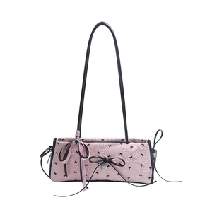 Borsa a spalla rosa con fiocco, trama a rilievo e tracolla lunga sottile nera