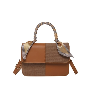 Brown patchwork handbag with decorative silk scarf handle and adjustable strap
