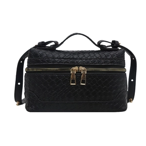 Solid black woven box handbag with dual gold zippers and adjustable shoulder strap