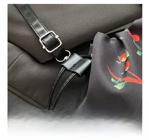 Detail of silver hardware buckle and floral fabric on drawstring handbag shoulder strap