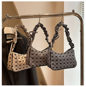 Detail of plaid jacquard shoulder bags with bow patterns and ruffled strap design