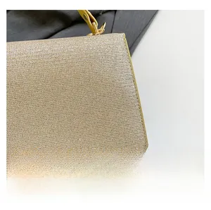 Close-up of champagne gold evening clutch with shimmering texture and refined stitching