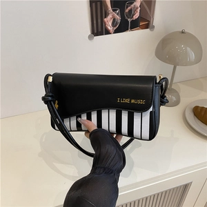 Chic piano key crossbody bag with I LIKE MUSIC lettering and woven rope shoulder strap