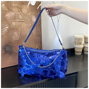 Detail of blue sequin shoulder bag with silver metal chain and smooth zipper closure