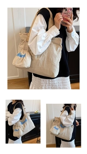 Close-up of beige nylon tote bag and drawstring pouch with blue Beach letter embroidery