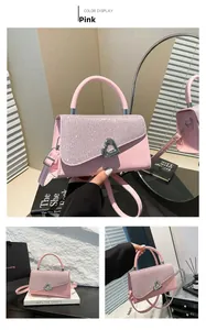 Detailed view of pink crossbody bag featuring sequined flap and silver heart lock