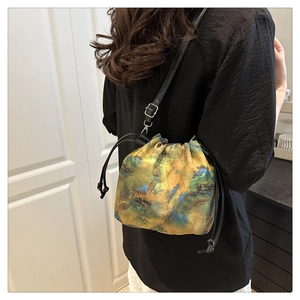 Detail of drawstring bucket bag with traditional landscape print on silk fabric