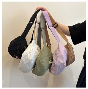 Detailed display of five colorful nylon crossbody bags with adjustable straps and zip pockets
