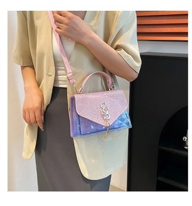 Close-up of glitter pink flap and transparent purple quilted PVC on crossbody bag
