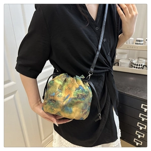 Detail of a drawstring bucket bag with traditional Chinese landscape embroidery on silk fabric