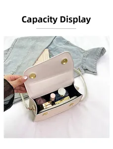 Detail showing internal capacity of the beige crossbody bag with cosmetics and gold hardware