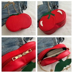 Detailed views of red cherry crossbody bag with gold chain and interior storage