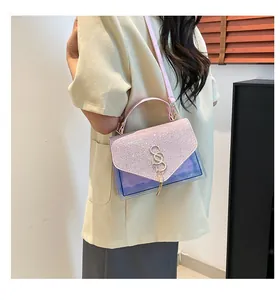 Detail of pink purple glitter crossbody bag with S-letter gold buckle and chain strap