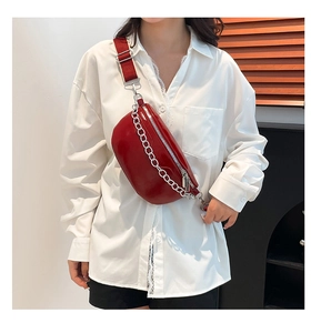 Close-up of red PU crossbody chest bag featuring a chunky silver chain and fashion logo