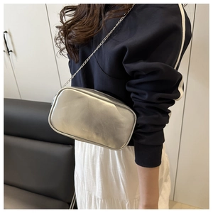 Detail of silver metallic crossbody bag with chain strap and Fashion Bags embossing