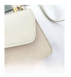 Close-up of elegant contrast stitching and woven texture on a white summer flap bag