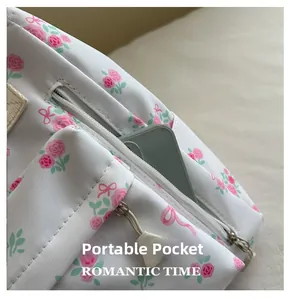 Detail of floral canvas backpack showing portable zipper pocket with a smartphone inside