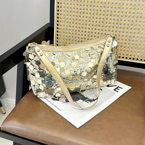 Fashionable large crescent shoulder bag with shiny gold and silver sequins and chain strap