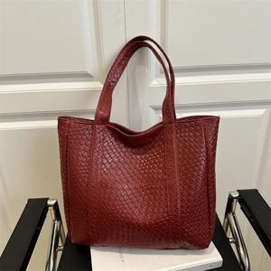 Minimalist deep red woven leather tote bag with a spacious interior for stylish daily use