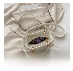 Interior view showing capacity for lipstick and compact in a quilted cream crossbody bag