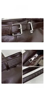 Close-up of dark brown glossy PU leather baguette bag with silver buckle and fine stitching