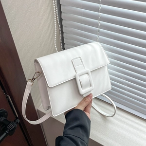 Chic white PU leather crossbody bag featuring a large square buckle and gold hardware