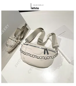 Close-up of white minimalist waist bag with chunky metal chain and FASHION embossed logo