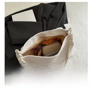 Vue détaillée de l'intérieur du grand sac à bandoulière tressé blanc avec chaîne