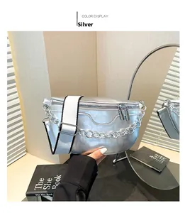Close-up of silver leather waist bag with Fashion embossing and wide textile strap