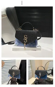 Detail of transparent blue PVC crossbody bag with glitter flap and gold SS metal buckle