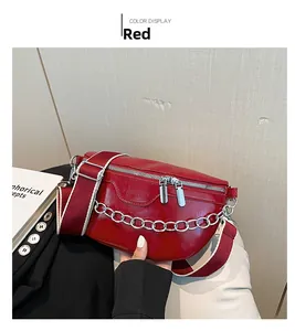Detail of red glossy chain waist bag with bicolor canvas strap and silver hardware