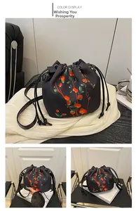 Detail of drawstring bucket bag featuring red persimmon prints and Chinese style aesthetics