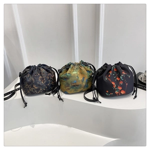 Three drawstring bucket bags featuring diverse artistic oil painting prints and leather straps