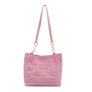 Pink quilted shoulder bag with chain strap and brand label for women commuting