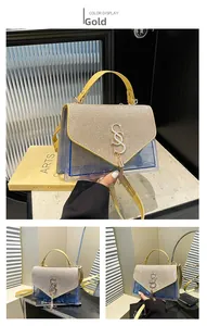 Detailed view of the gold glitter flap and blue PVC quilted pattern on a stylish handbag