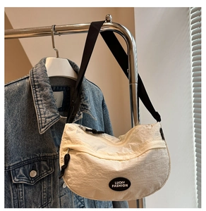 Detail of off-white crescent nylon crossbody bag with logo and adjustable strap