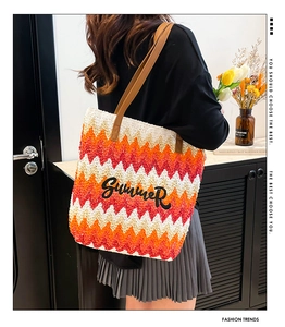 Detail of rainbow stripe woven tote with Summer embroidery and brown leather straps
