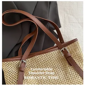 Detail of straw tote bag with brown leather strap and adjustable metal buckle hardware