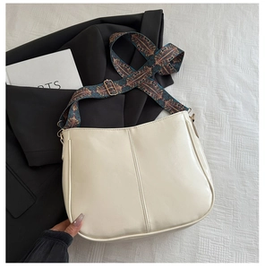 Detail of cream tote bag featuring adjustable ethnic style printed wide shoulder strap