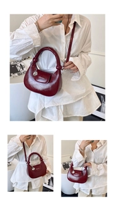 Macro detail of glossy dark red crescent bag with adjustable strap and top handle