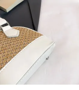Detail of woven straw texture and premium white leather trim on shell crossbody bag