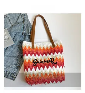 Detail of colorful zigzag woven tote bag with Summer embroidery and brown leather handles