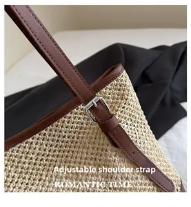 Detail of adjustable leather strap and silver buckle on a straw tote beach bag