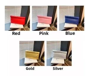 Detail view of woven leather envelope clutches in red, pink, blue, gold, and silver colors