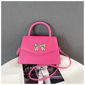 Hot pink bow-knot handbag with gold metallic hardware and smooth synthetic leather texture