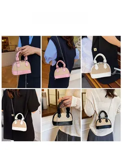 Detail view of woven shell-shaped handbags in pink, white, and black with chain straps
