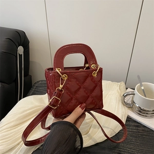 Elegant wine red quilted mini handbag with gold hardware and adjustable strap